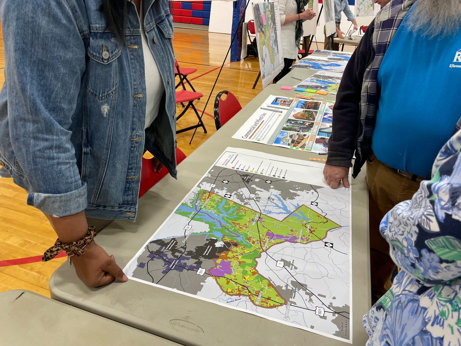 Maps on display at a community input session for Plan Moncure at Moncure School on Tuesday show zoning codes, stormwater management and housing types in the current Moncure area.